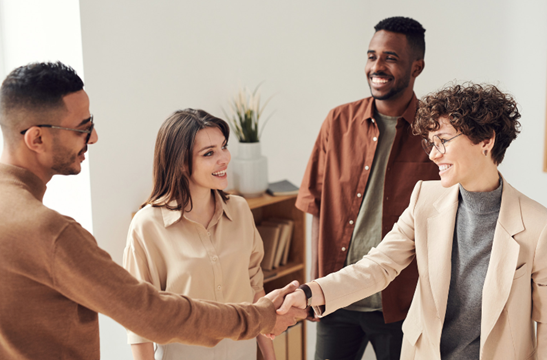 Group_of_people_smiling_and_shaking_hands.jpeg